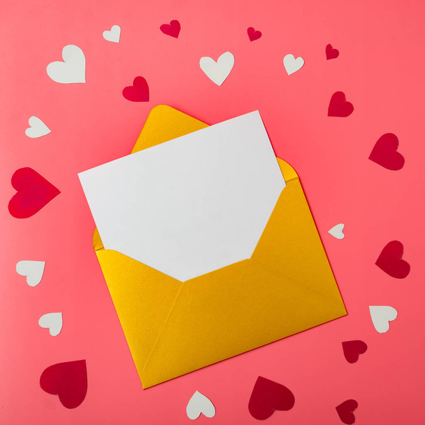 Love letter. Gold envelope on a red background with hearts. Place for your text. - Foto, immagini