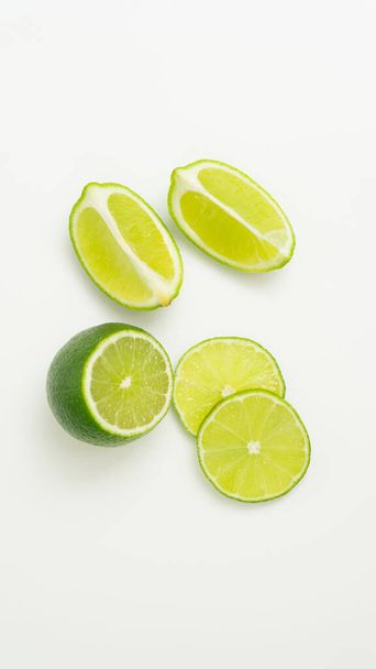 Kypsä vihreä sitrushedelmälimetti viipale valkoisella pohjalla. isolaatti - Valokuva, kuva
