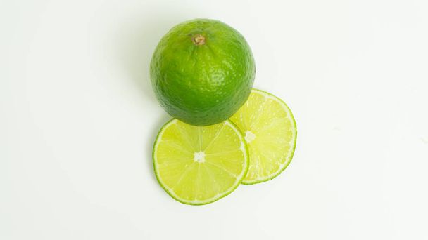 Ripe green lime citrus lime slice on white background. isolate - Photo, Image