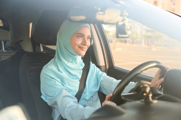 Young Muslim woman in modern car - Foto, Imagen