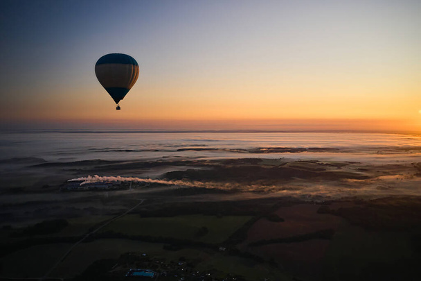 Landscape with a balloon against the sky at sunrise in summer - Fotó, kép