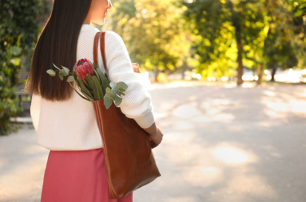 Woman with leather shopper bag in park, closeup - Foto, Imagem