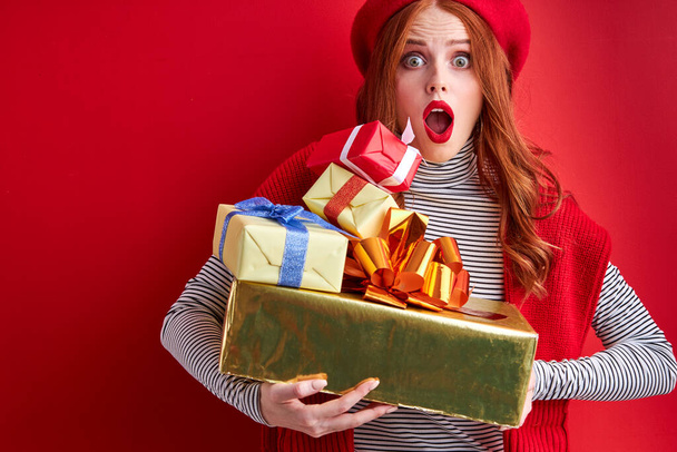 excited shocked female holding gift boxes in hands - Fotoğraf, Görsel