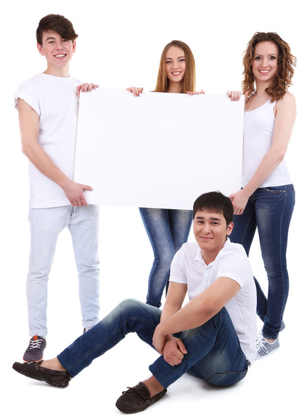Group of happy young people holding blank poster isolated on white - Fotó, kép