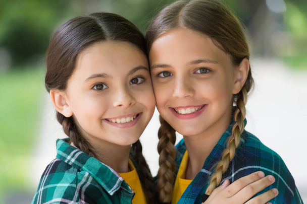 Happy girls smile with cute look wearing long hair in plaits summer outdoors, beauty - Foto, Imagem