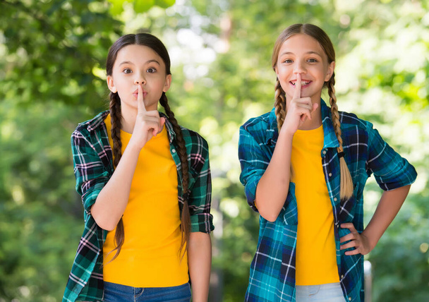 Silence is golden. Little children put fingers on lips. Silence concept. Making hush sign. Quite sound gesture. Secret or confidential. Friends and friendship. Summer vacation. Keeping mouth shut - Photo, image
