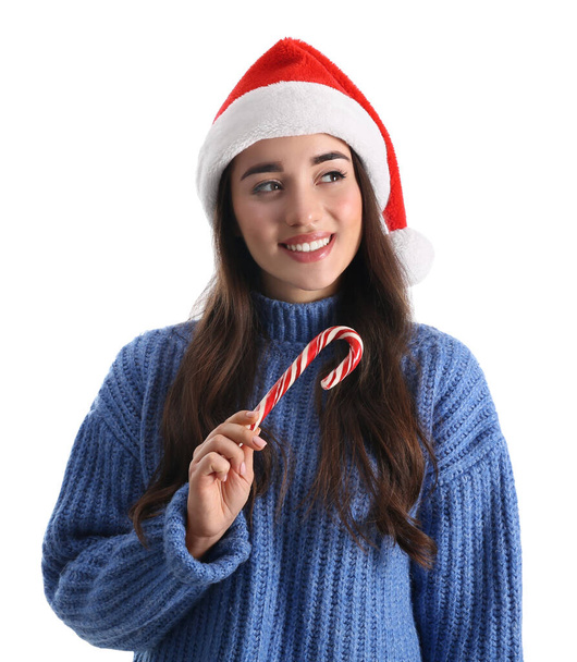 Beautiful woman in Santa Claus hat holding candy cane on white background - Φωτογραφία, εικόνα