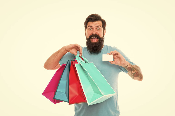 Payment method. day of sell out. man showing credit card. Very good offer. nice purchase. Big Sale online in our shop. ready to pay online. successful shopping. bearded man carry heavy shopping bags - Photo, image
