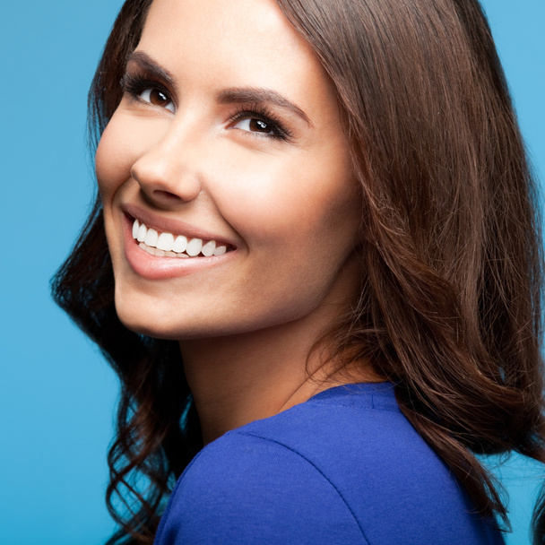 Happy smiling young woman, over blue - Φωτογραφία, εικόνα