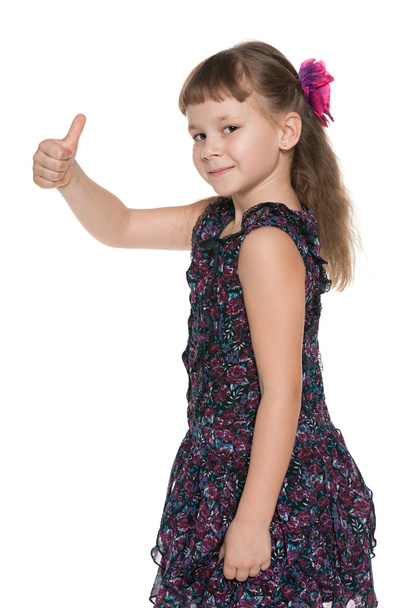 Fashion little girl holds her thumb up - Photo, Image