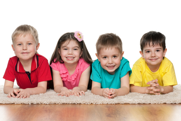 Four children on the white carpet - Foto, afbeelding