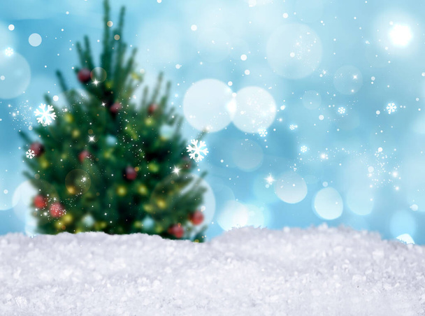 Snow and blurred view of beautiful decorated Christmas tree. Bokeh effect - Fotó, kép