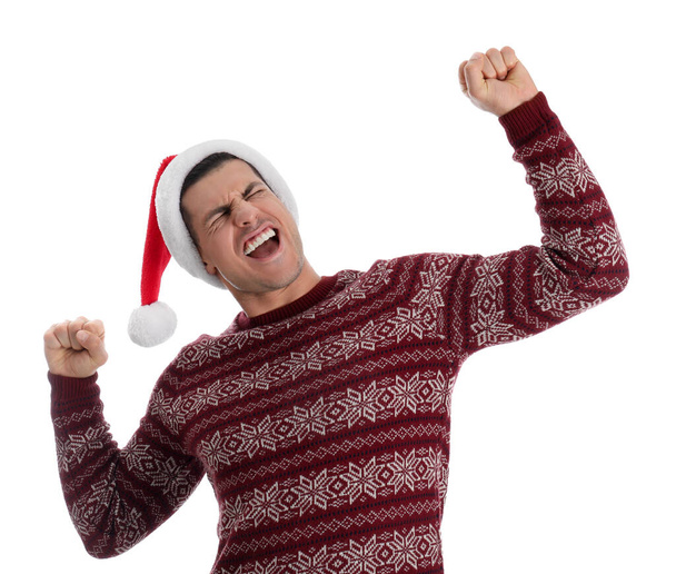 Excited man wearing Santa hat on white background - 写真・画像