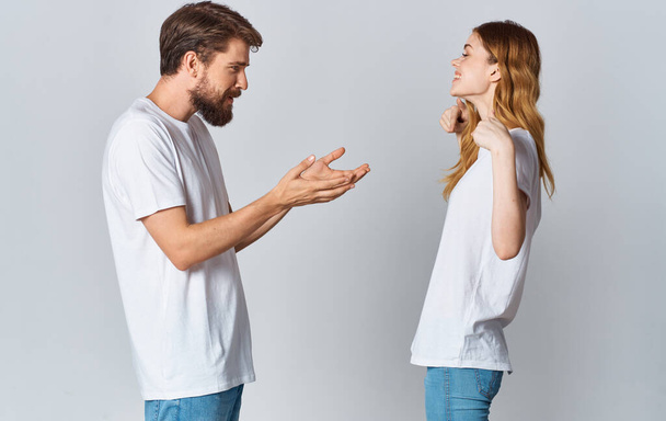 handsome guy explains something to a young woman on a light background cropped view family Copy Space - 写真・画像