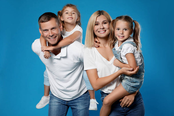 Happy family with children on blue background - Фото, изображение
