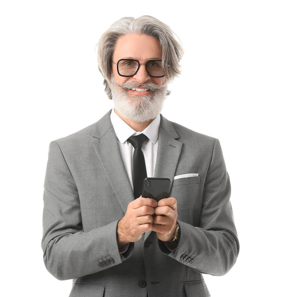 Portrait of senior businessman with mobile phone on white background - Foto, Imagen