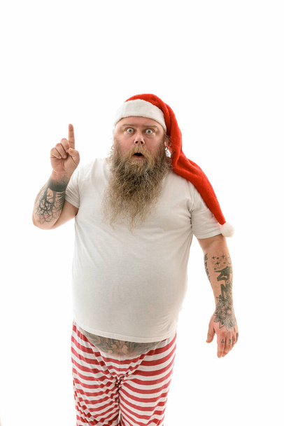 Emotional fat funny and tattooed man isolated on a white background - Foto, imagen