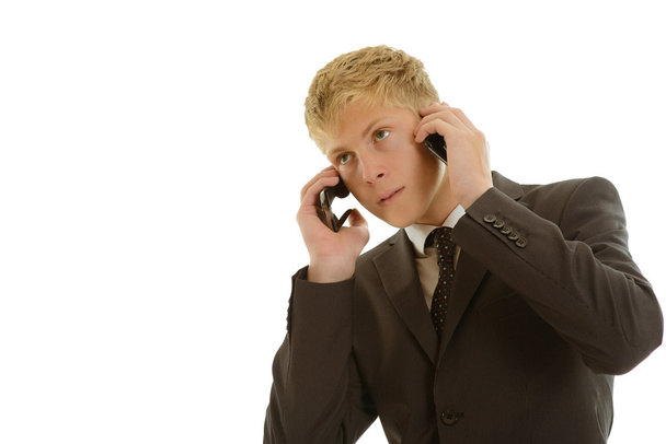 Businessman calls at two mobilephones - Foto, afbeelding