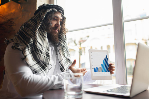 Arabian businessman working in office, business centre using devicesm gadgets. Lifestyle - Fotografie, Obrázek
