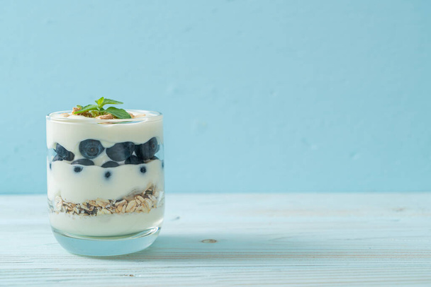 fresh blueberries and yogurt with granola - Healthy food style - Fotó, kép