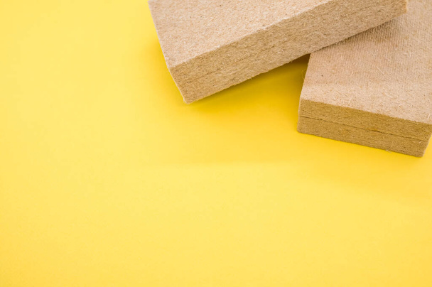 A high angle shot of building thermal insulation materials isolated on yellow background - Fotografie, Obrázek
