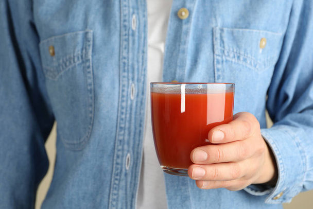 Woman hold glass of tomato juice, close up - 写真・画像
