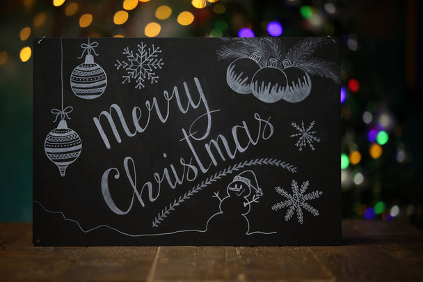 A Christmas composition with a black chalkboard on the table - Fotoğraf, Görsel