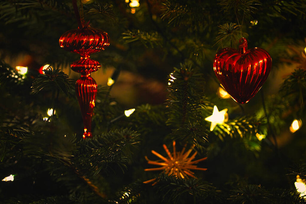 A close up of christmas tree decorations with some bokeh lights to feel the christmas mood. - Fotografie, Obrázek