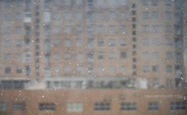 Lluvia densa cae sobre edificio borroso en el fondo - Foto, imagen