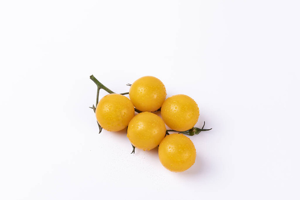 Yellow cherry tomatoes isolated on a white background - Foto, imagen