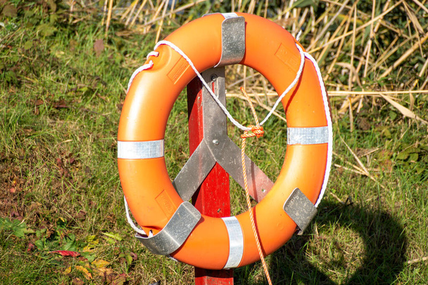 Lifebuoy on bracket on a meadow - Photo, Image