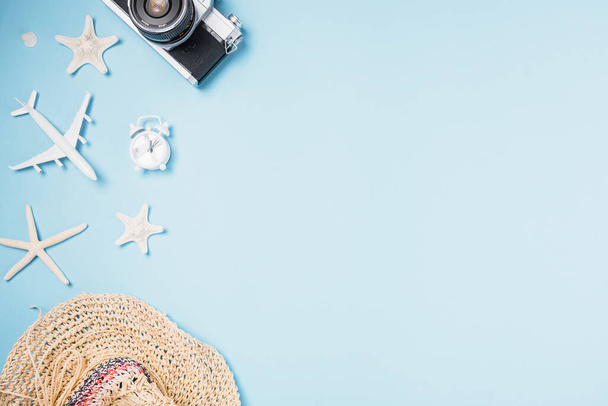 Flat lay top view mockup retro camera films, airplane, starfish, shells, hat traveler tropical accessories on a blue background with copy space, Business trip, and vacation summer travel concept - Фото, зображення
