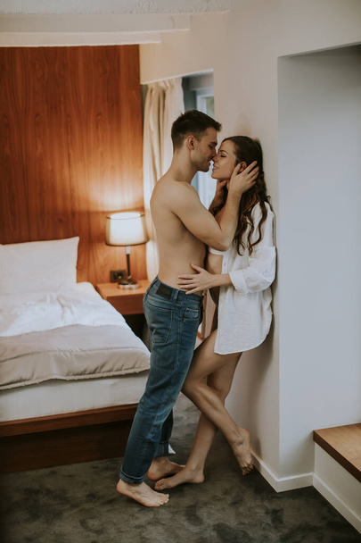 Jovem casal abraçando no quarto do apartamento - Foto, Imagem