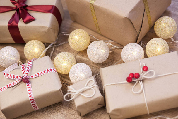 Sfondo natalizio con scatole regalo, ghirlanda su sfondo di legno - Foto, immagini