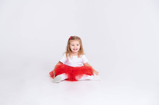 toddler girl in red skirt and white t-shirt on white background. Valentine Day concept - Foto, Imagem