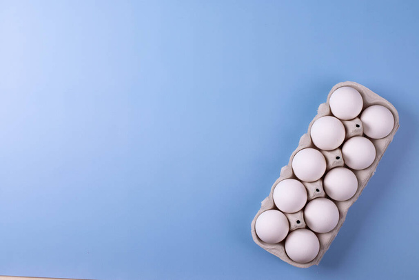 white eggs and milk as calcium concept. minimalism style. - Photo, Image