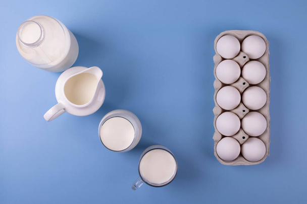 white eggs and milk as calcium concept. minimalism style. - Фото, изображение