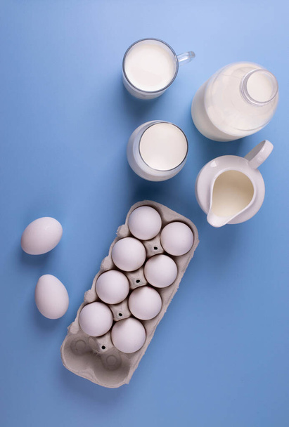 white eggs and milk as calcium concept. minimalism style. - Фото, изображение