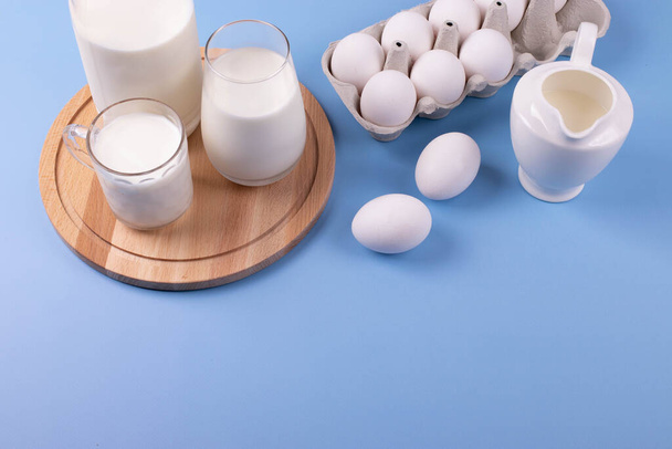 white eggs and milk as calcium concept. minimalism style. - Zdjęcie, obraz