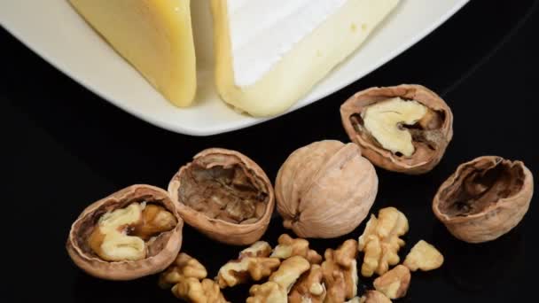 Walnuts with and without peels and Parmesan and Brie cheese (zoom in). - Footage, Video