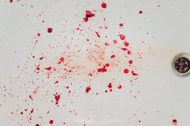 Blood draining from white bathroom basin. Bloody stains in the waterbasin hole. - Fotoğraf, Görsel
