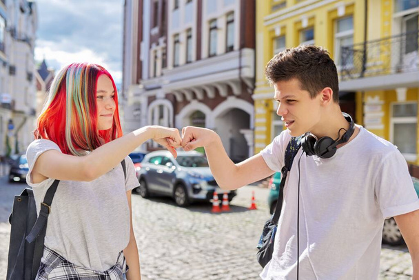 Teenage boy and girl meeting, greeting with hands - Foto, Imagen
