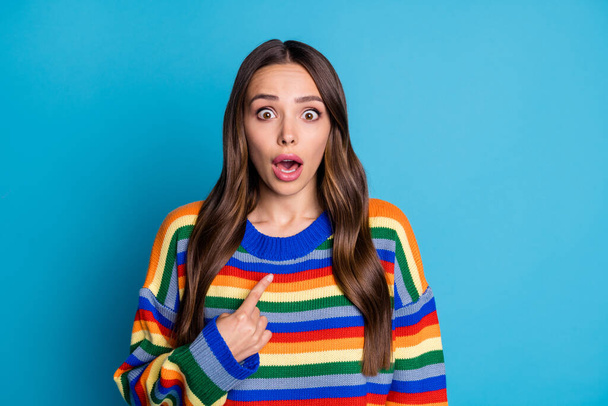 Photo of astonished horrified girl hear terrified choice decision news point index finger copyspace stare stupor wear trendy pullover isolated over blue color background - Photo, Image