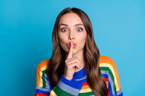 Close-up portrait of her she nice attractive lovely funny mysterious brown-haired girl wearing casual sweater showing shh sign isolated bright vivid shine vibrant blue color background - Fotó, kép