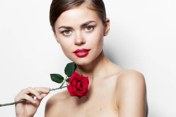Женский портрет Красные губы розовый цветок чистая кожа модели длинные волосы  - Фото, изображение
