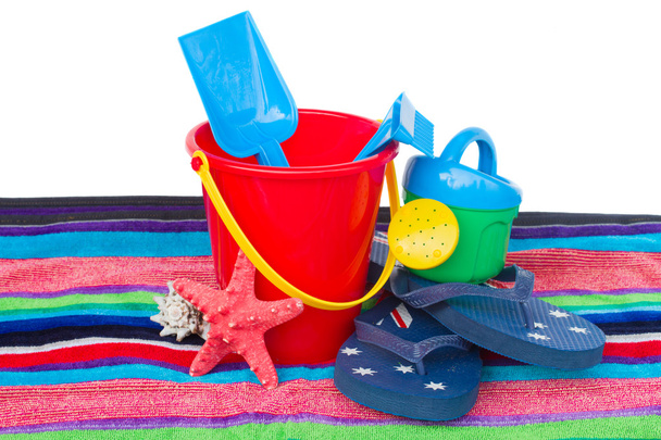 Beach toys with flip flops and starfish on towel - Foto, Bild