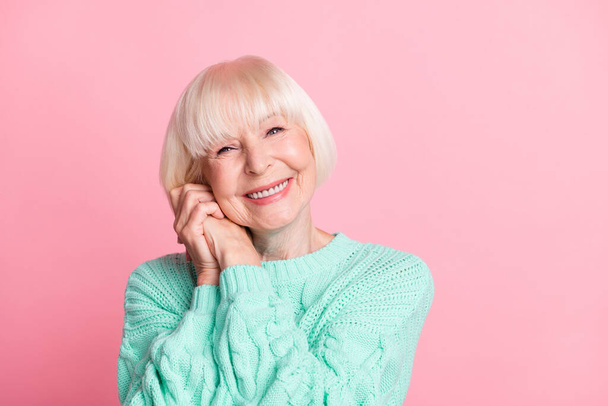 Photo portrait of lovely female pensioner blonde hair keeping hands together smiling isolated on pastel pink color background with copyspace - Foto, afbeelding