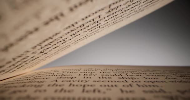 deslizándose dentro del libro entre hojas de papel con texto. concepto de conocimiento y educación - Metraje, vídeo