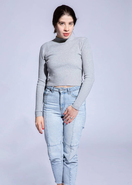 Standing girl in roll neck with big lips isolated on grey - Foto, Imagem