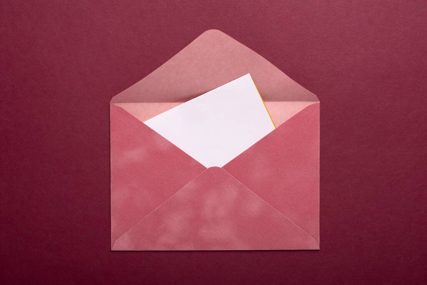 Pink envelope on a burgundy background - Fotó, kép